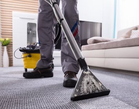 Picture of janitor cleaning carpet at work