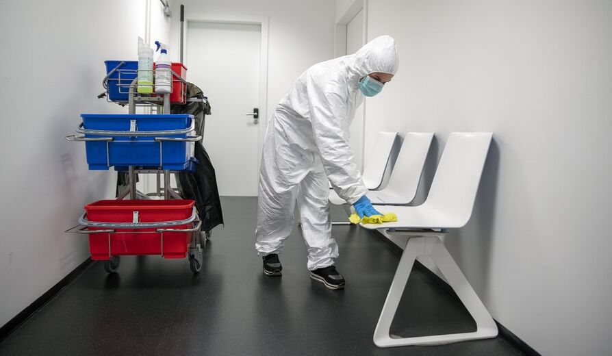 Picture of worker disinfecting a chair
